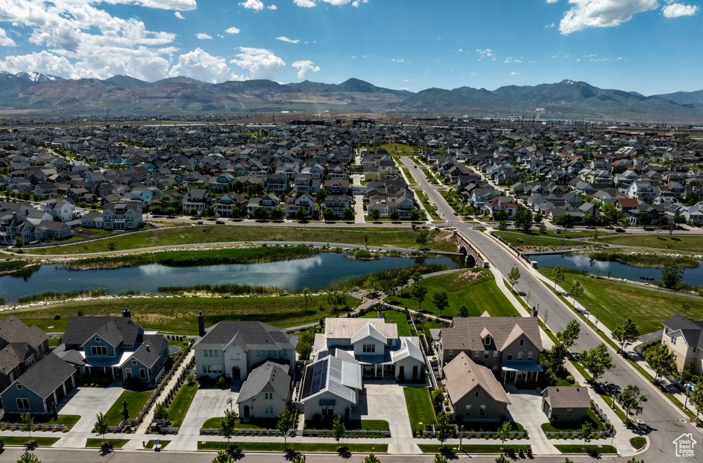 Birds eye view of property with a water and mountain view