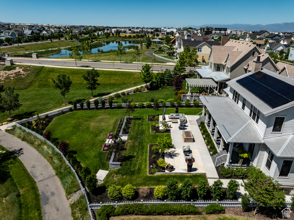 Birds eye view of property with a water view
