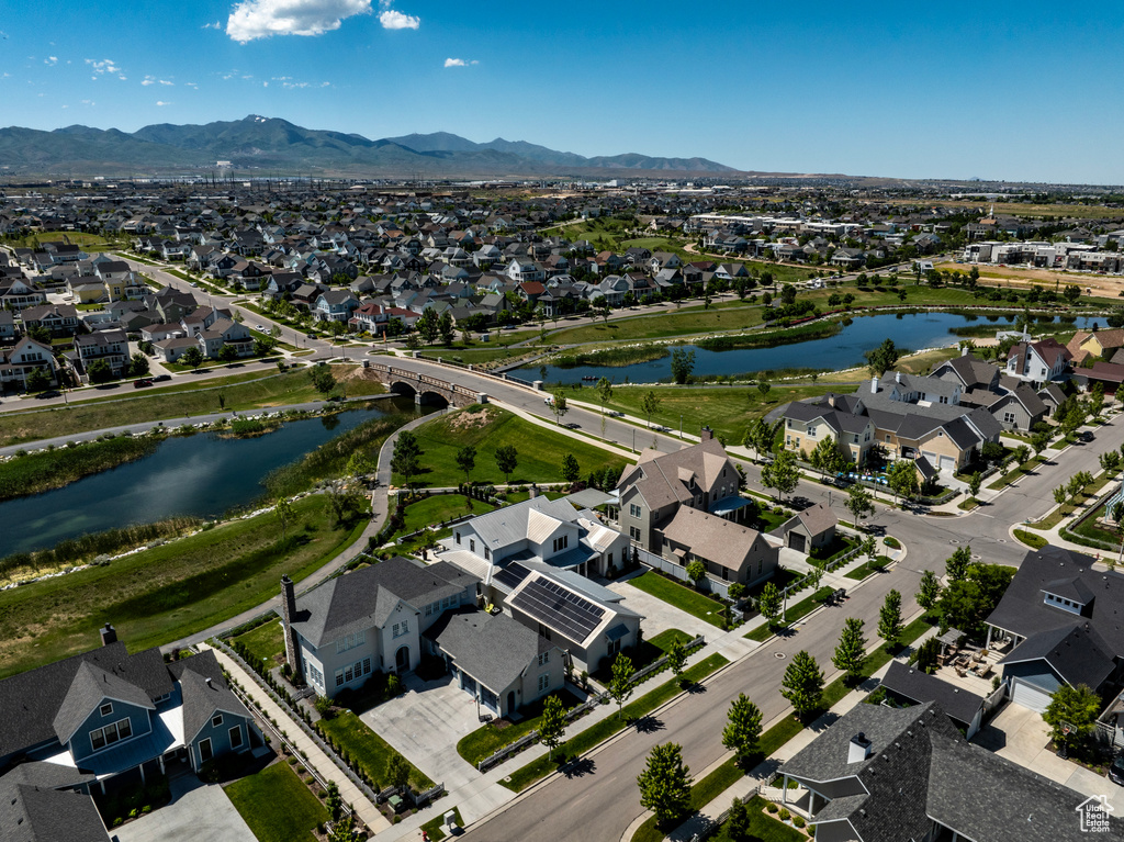 Birds eye view of property with a water and mountain view