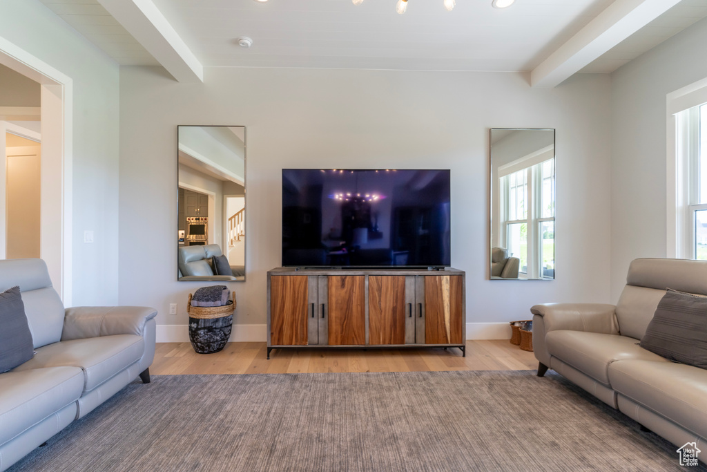 Living room featuring beamed ceiling and light hardwood / wood-style floors