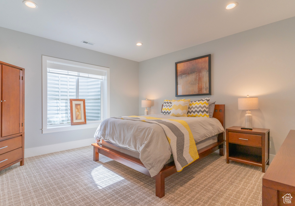 Bedroom with light colored carpet