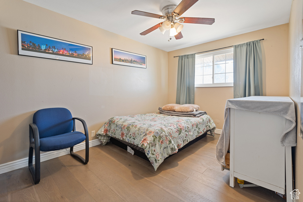 Bedroom with baseboards, ceiling fan, and light wood finished floors