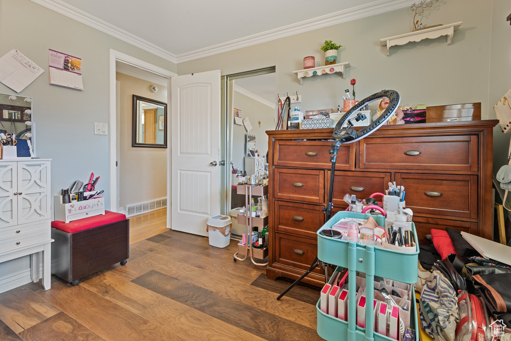 Interior space featuring crown molding and wood finished floors