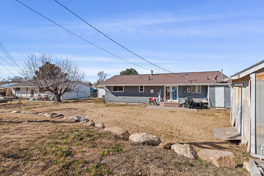 Back of house with entry steps and fence