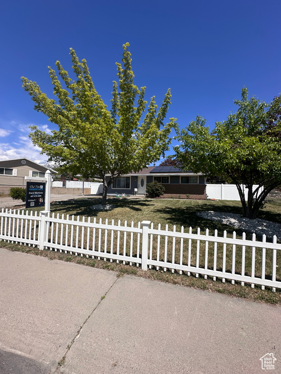Obstructed view of property featuring a fenced front yard