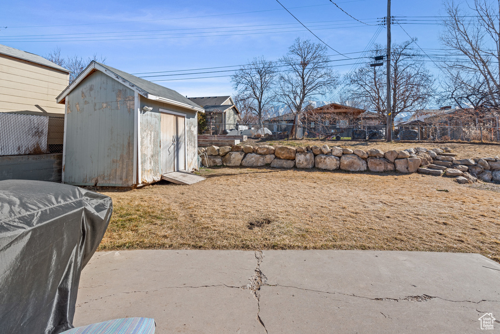 View of yard featuring an outbuilding and a shed