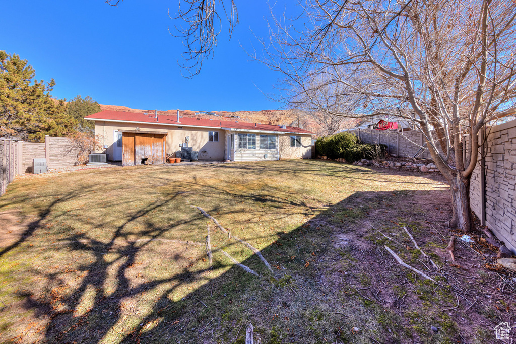 Back of property featuring cooling unit