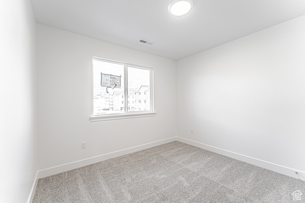 Unfurnished room with carpet flooring and baseboards