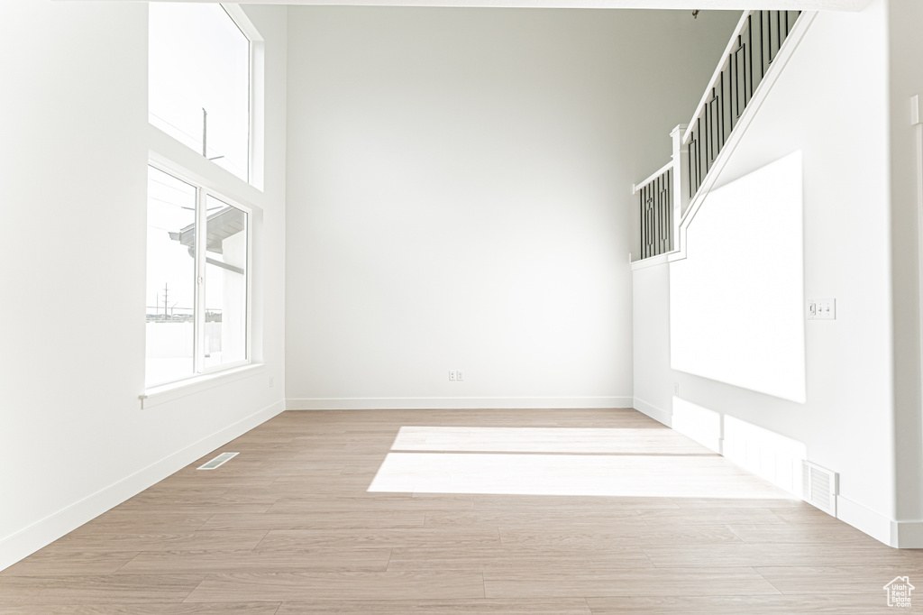 Unfurnished room with light wood-style flooring and baseboards