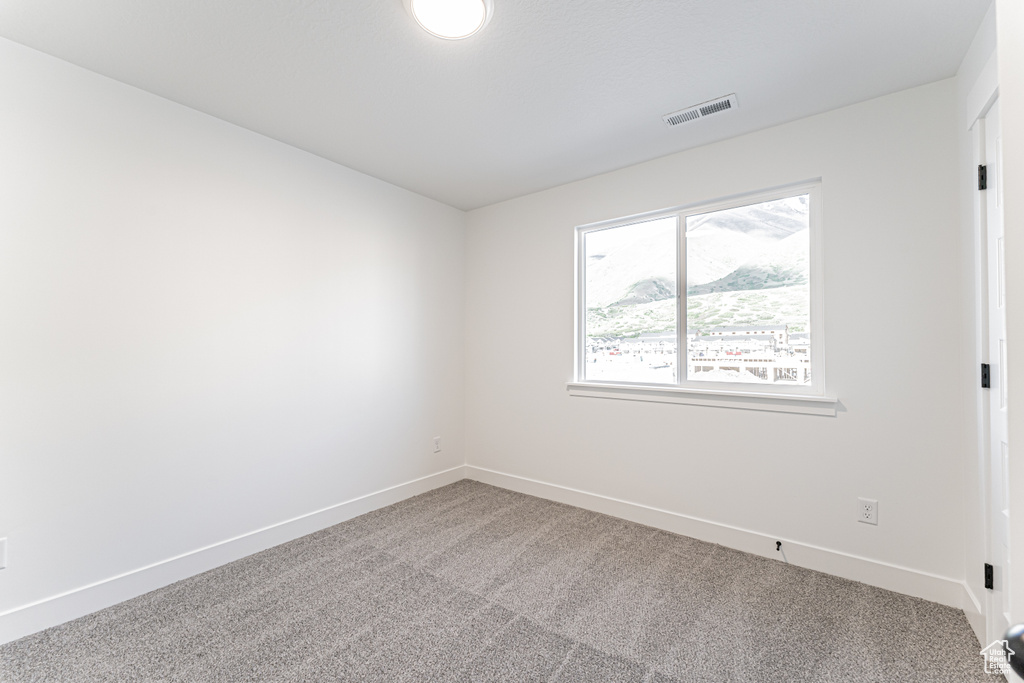 Carpeted empty room with baseboards