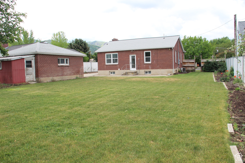 Back of house featuring brick siding