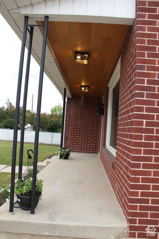 View of patio featuring fence