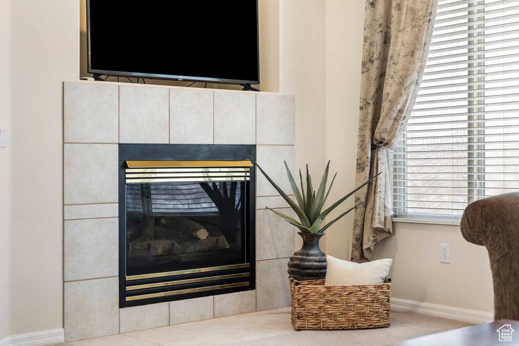 Detailed view of baseboards and a tile fireplace