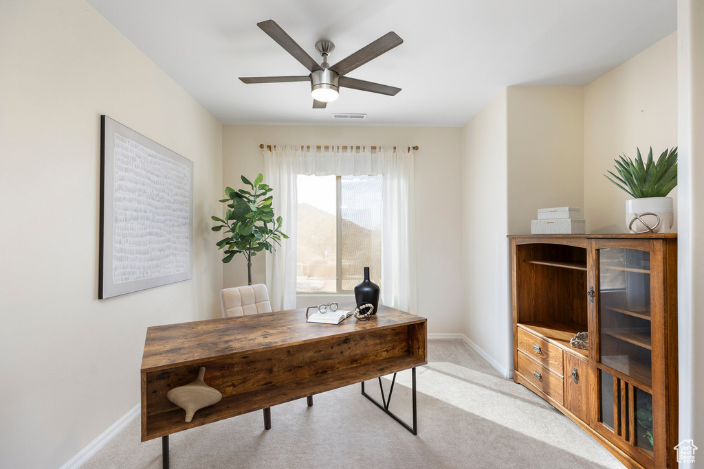 Home office with baseboards, light colored carpet, and ceiling fan