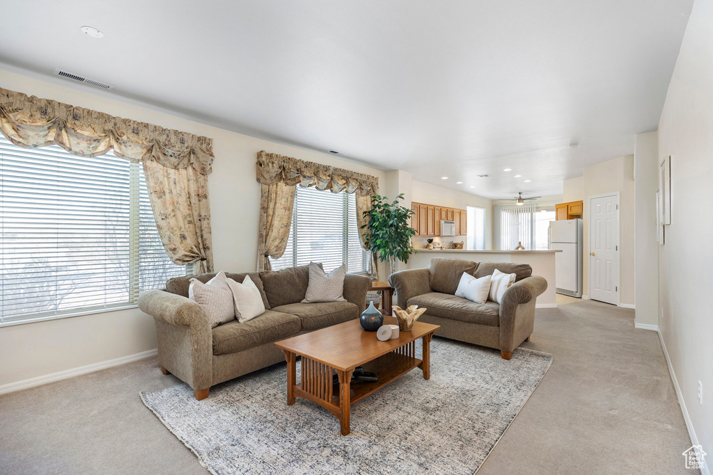 Living room featuring light carpet, baseboards, and recessed lighting