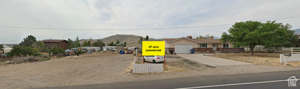 View of front of property with a garage and a mountain view