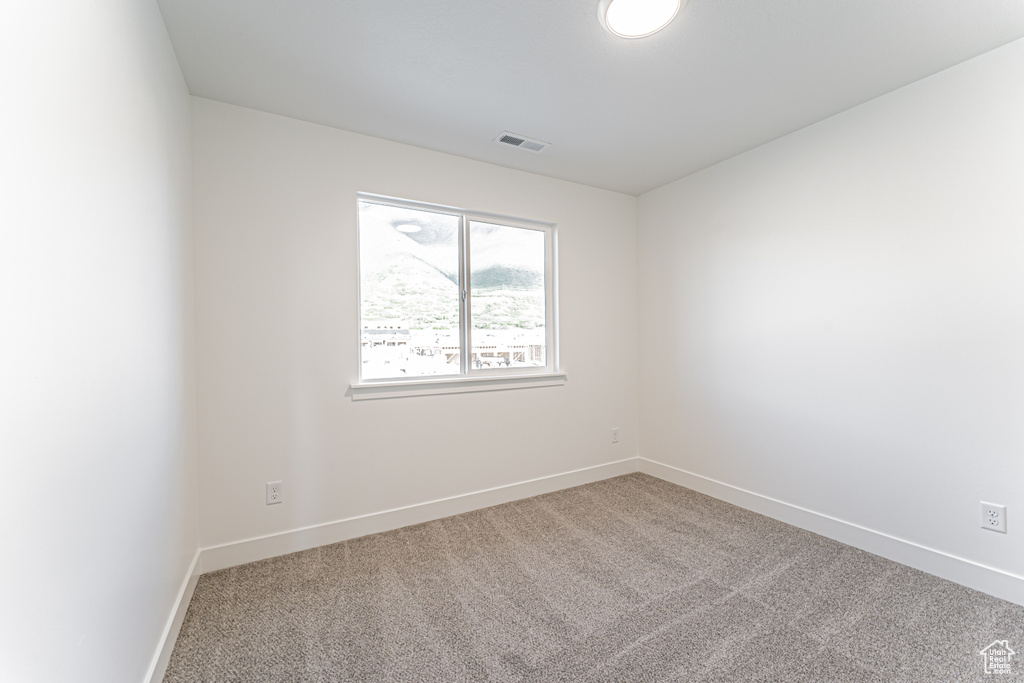Spare room with carpet floors and baseboards
