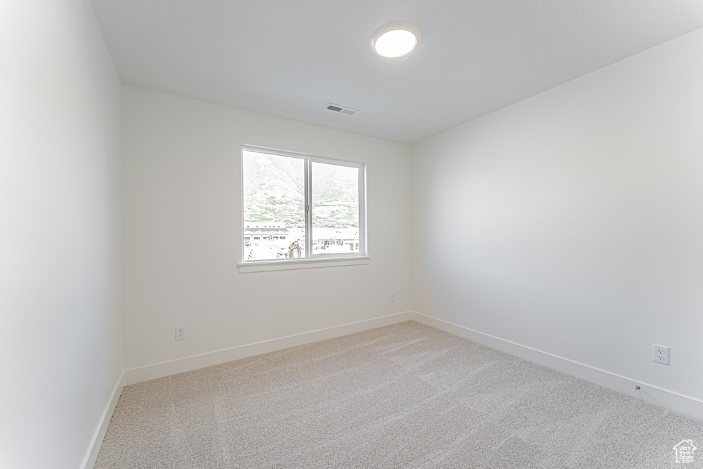 Unfurnished room with carpet and baseboards