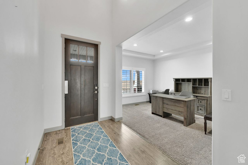 Entrance foyer with light wood-type flooring