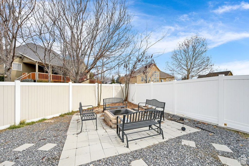 View of patio with an outdoor living space with a fire pit