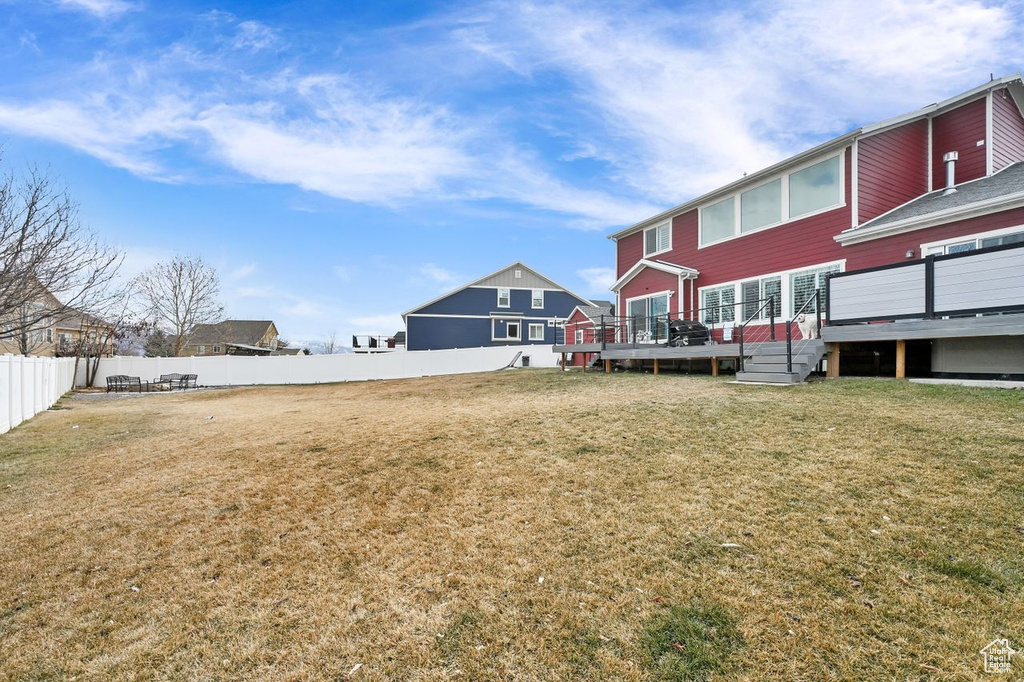 View of yard with a wooden deck