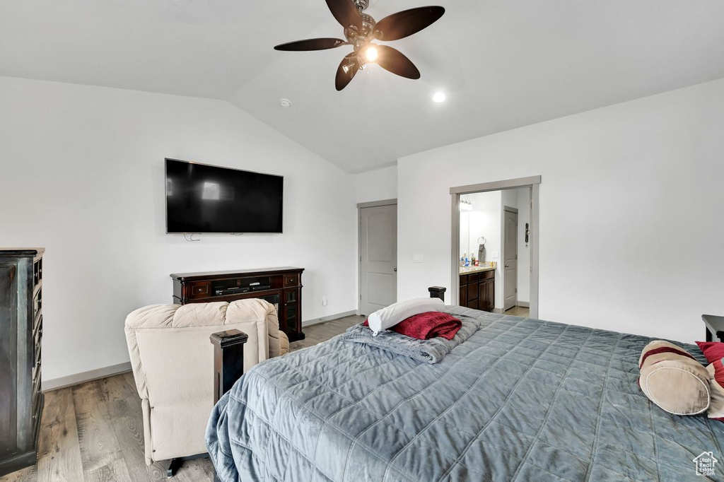 Bedroom featuring ceiling fan, lofted ceiling, and light wood-type flooring