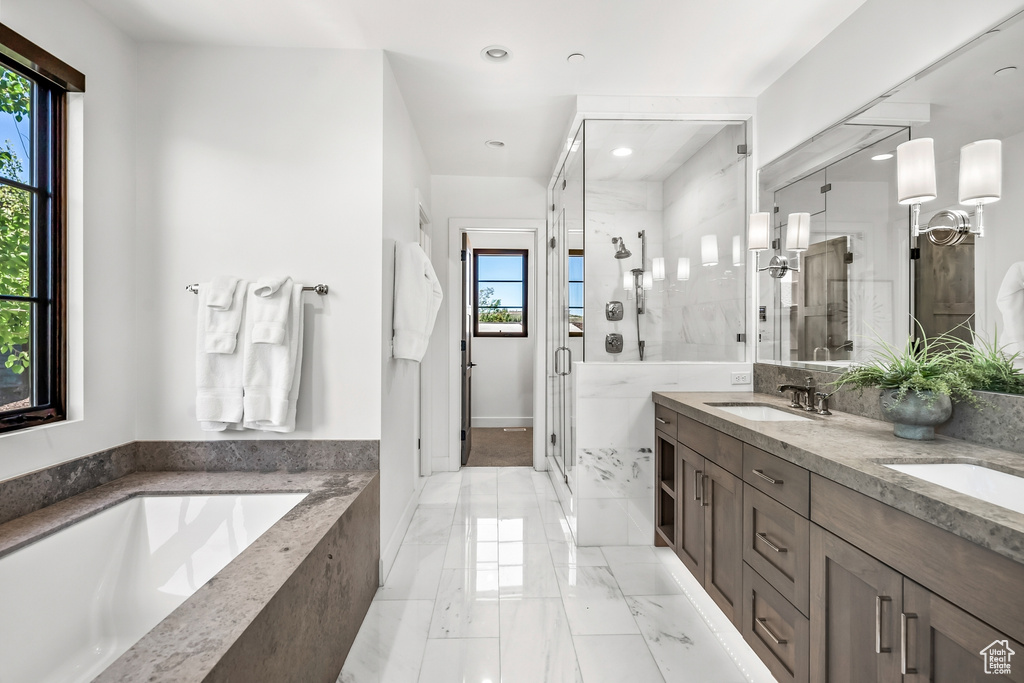 Bathroom with recessed lighting, a sink, a bath, a stall shower, and double vanity