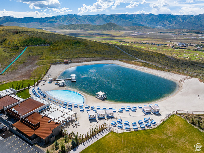 Birds eye view of property with a water and mountain view