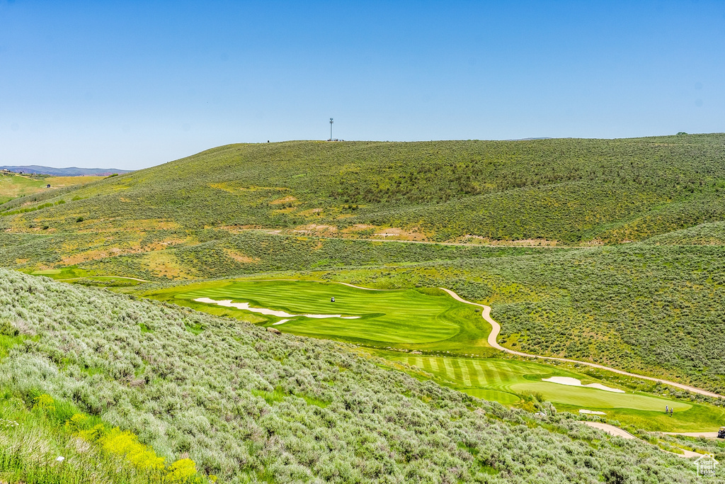Surrounding community with a mountain view and golf course view