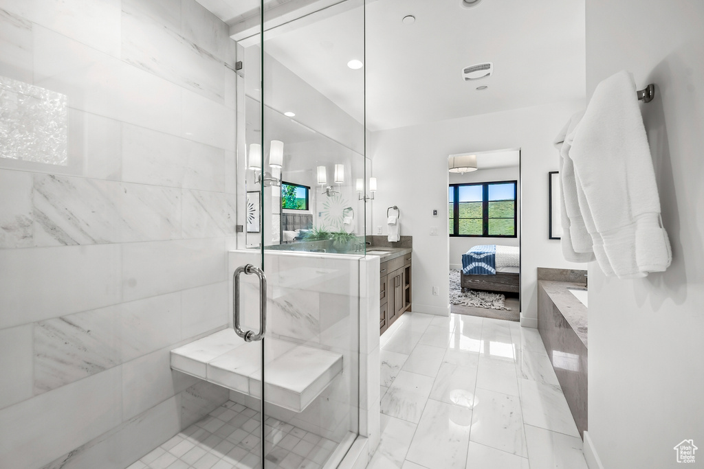 Ensuite bathroom with a shower stall, vanity, and ensuite bath