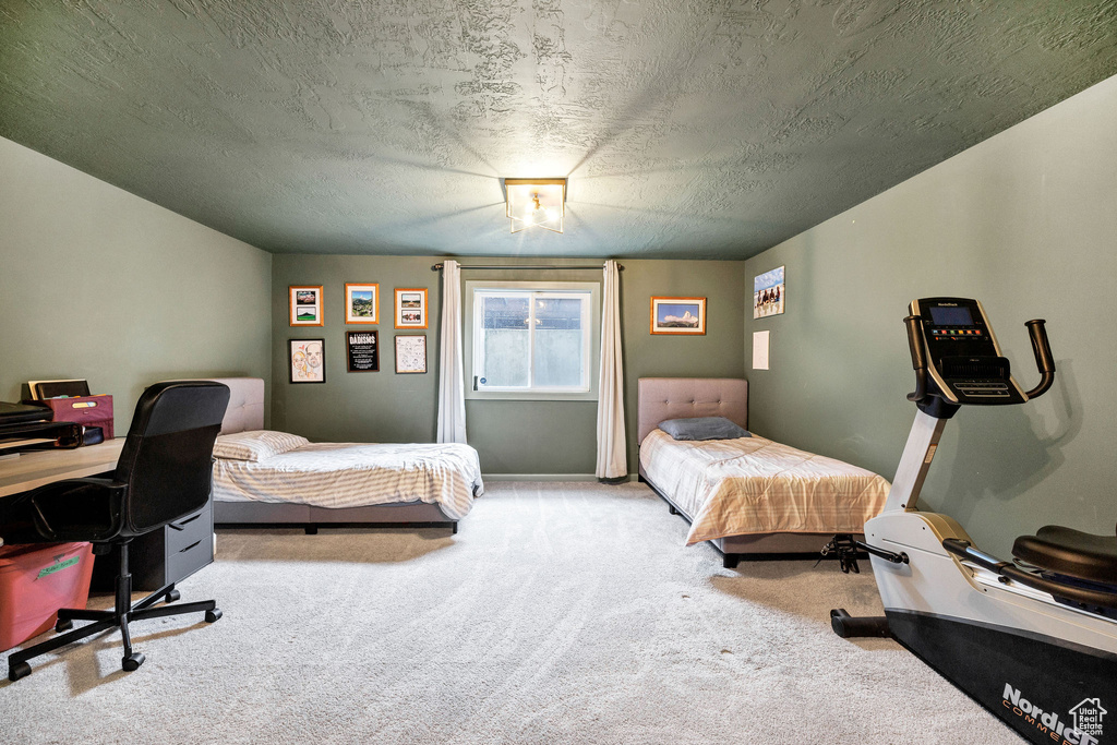 Carpeted bedroom featuring a textured ceiling