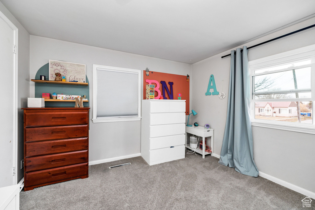 Bedroom with light colored carpet