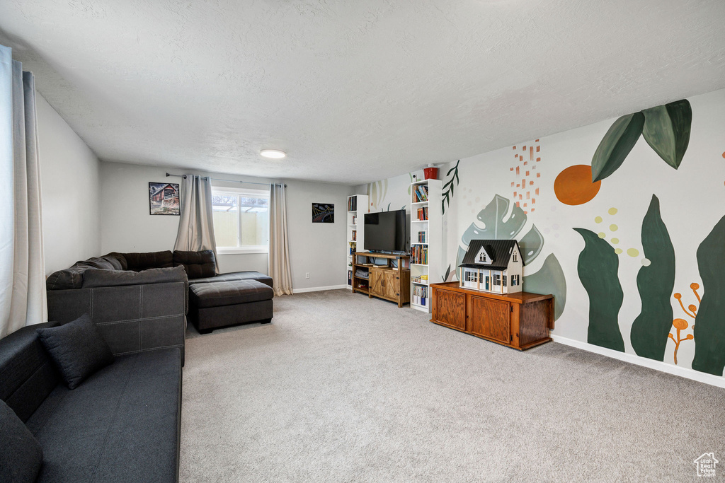 Living room with carpet floors and a textured ceiling