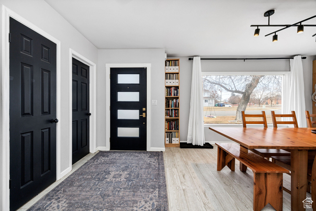 Foyer featuring wood-type flooring and track lighting