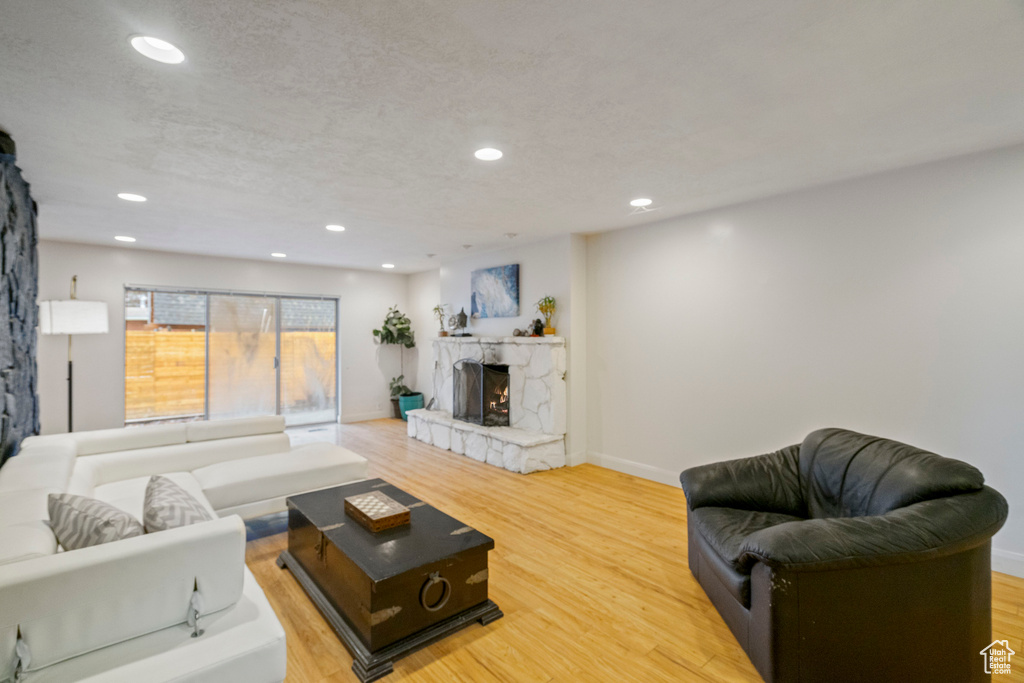 Living room with hardwood / wood-style flooring and a textured ceiling