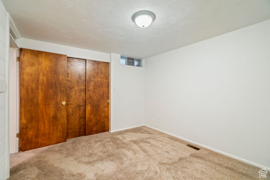 Unfurnished bedroom with a closet and carpet