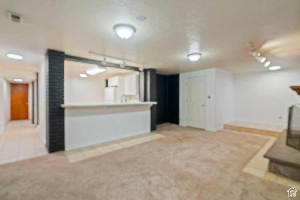 Unfurnished living room featuring carpet