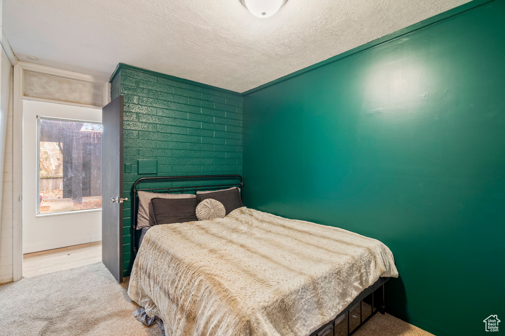 Carpeted bedroom featuring a textured ceiling