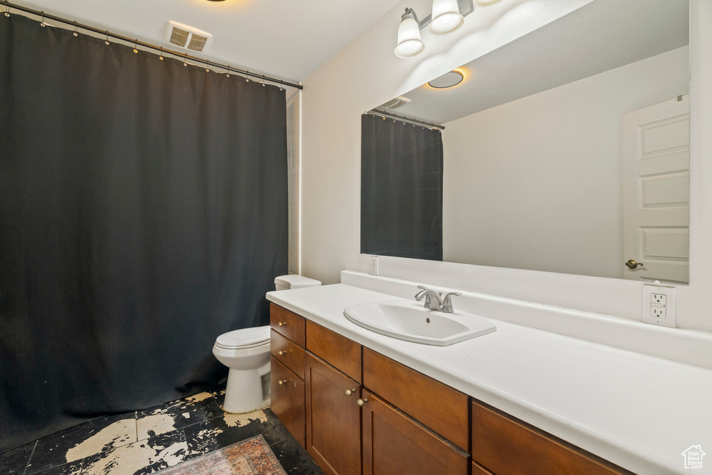 Bathroom featuring vanity and toilet