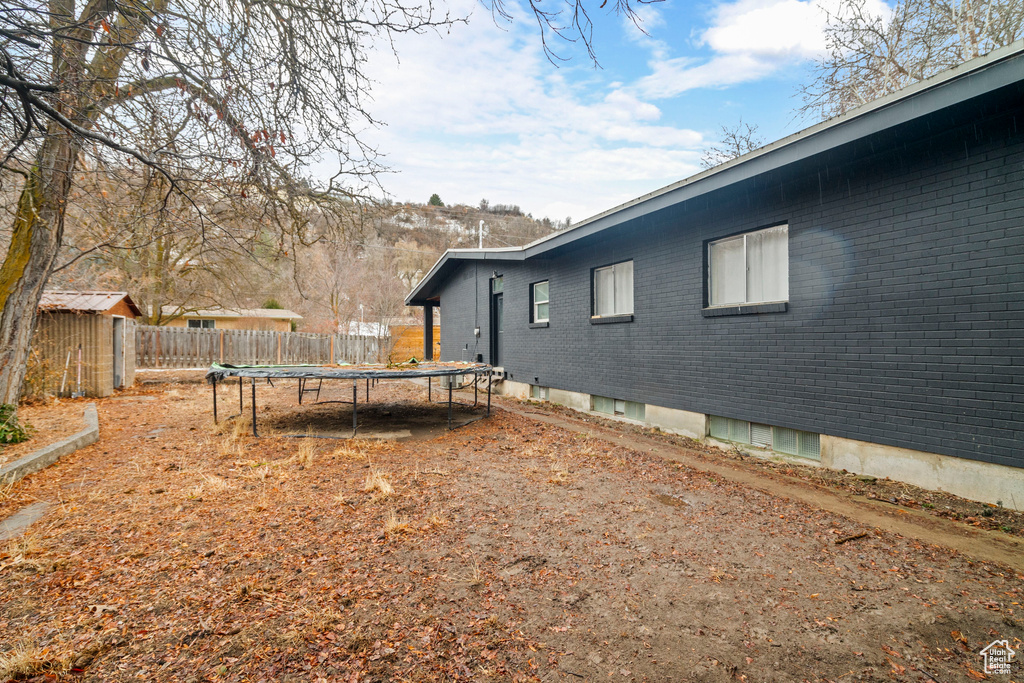 View of yard with a trampoline