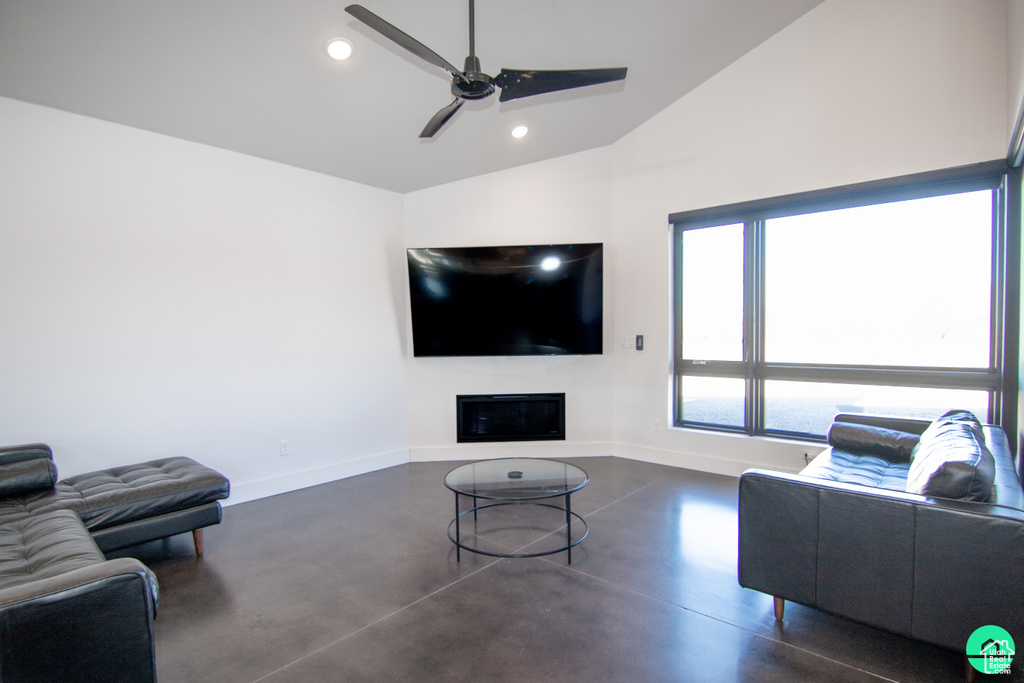 Living room with lofted ceiling and ceiling fan