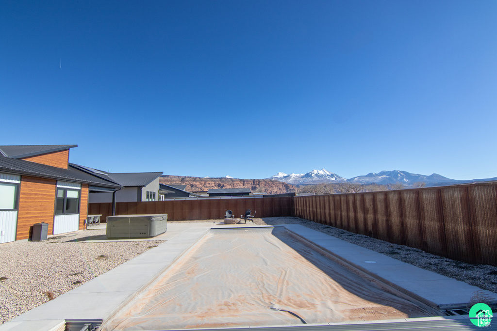 View of yard featuring a mountain view, a patio area, and a jacuzzi