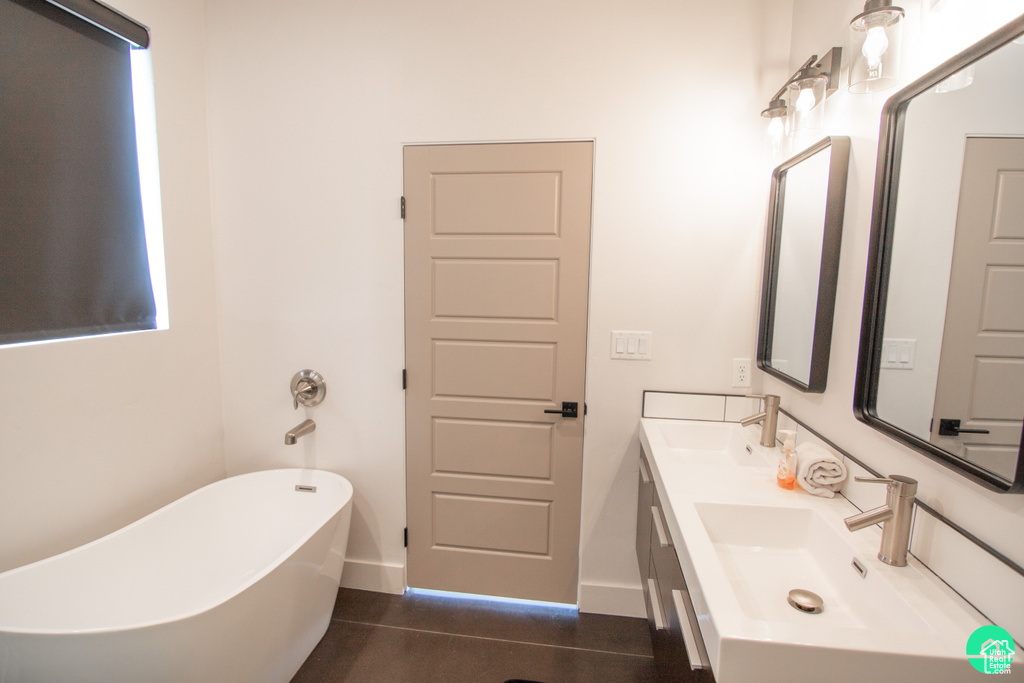 Bathroom featuring vanity and a tub