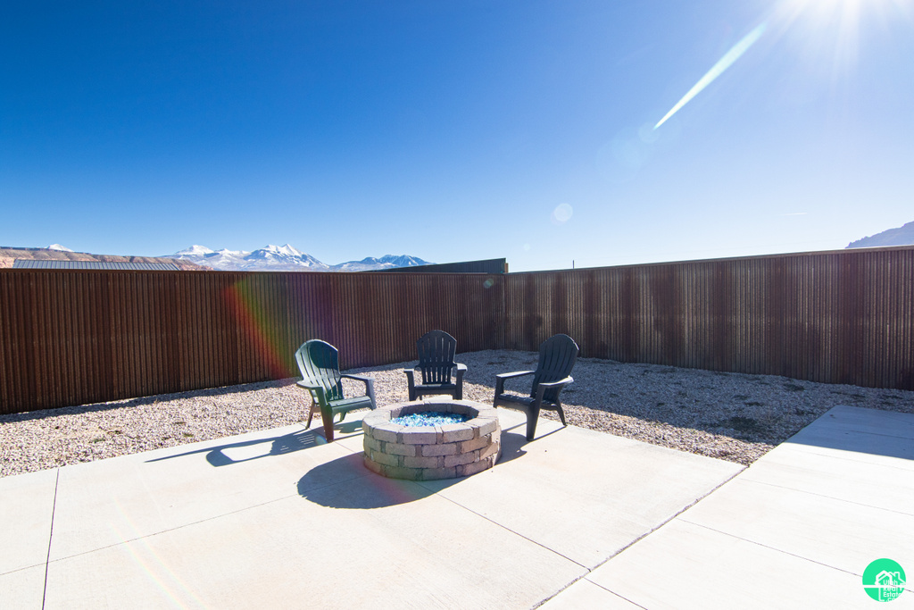 View of patio / terrace with a mountain view and a fire pit