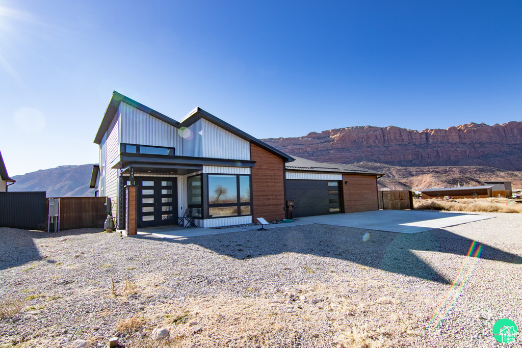 View of front facade with a garage and a mountain view