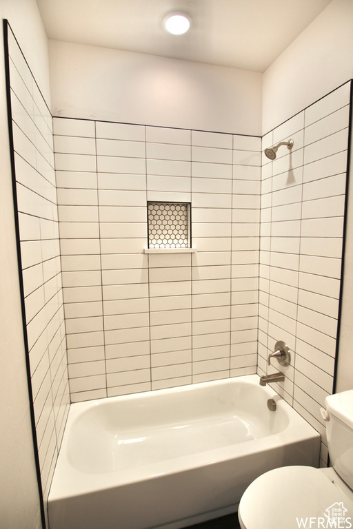 Bathroom featuring toilet and tiled shower / bath
