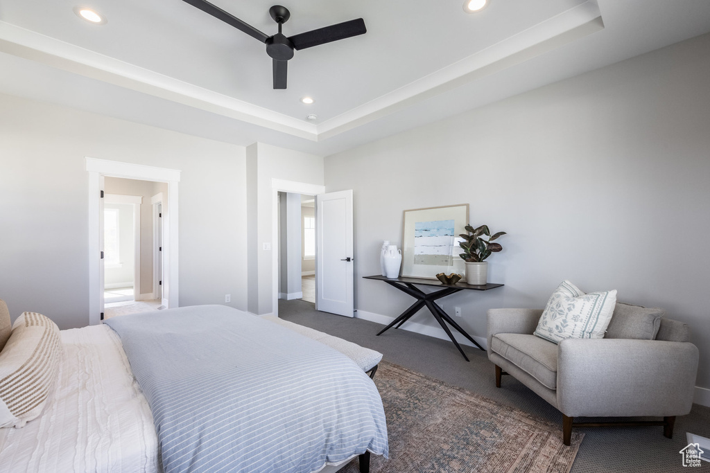 Bedroom featuring carpet floors, a tray ceiling, recessed lighting, a ceiling fan, and baseboards
