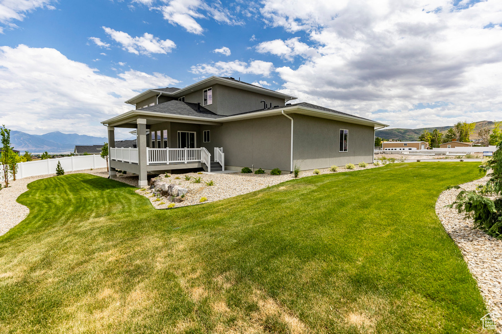 Back of property featuring a mountain view and stucco siding