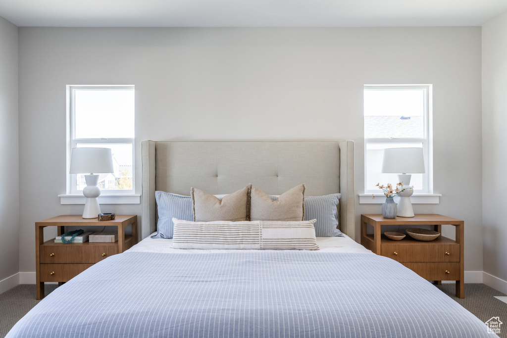 Bedroom featuring carpet floors and baseboards