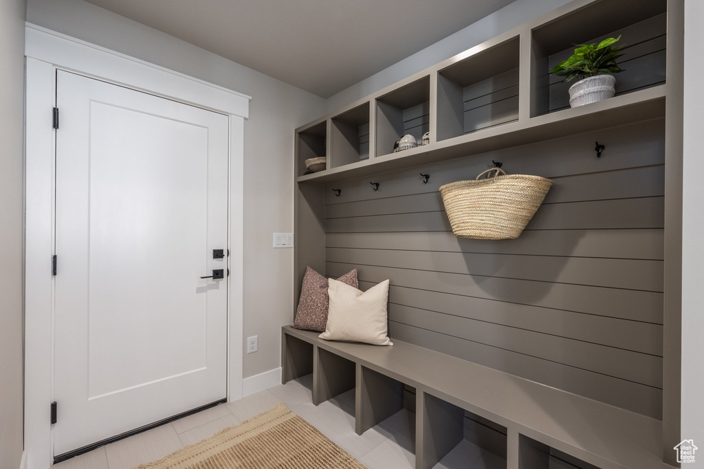 Mudroom featuring light tile patterned flooring and baseboards